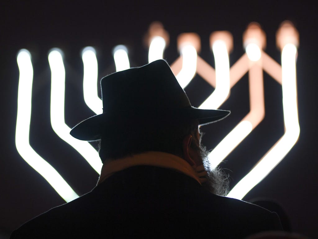 Rabbi Zalman Gurevitch stands in front of a Hanukkah  Menorah during the jewish festival of lights at Opernplatz in Frankfurt am Main, Germany.