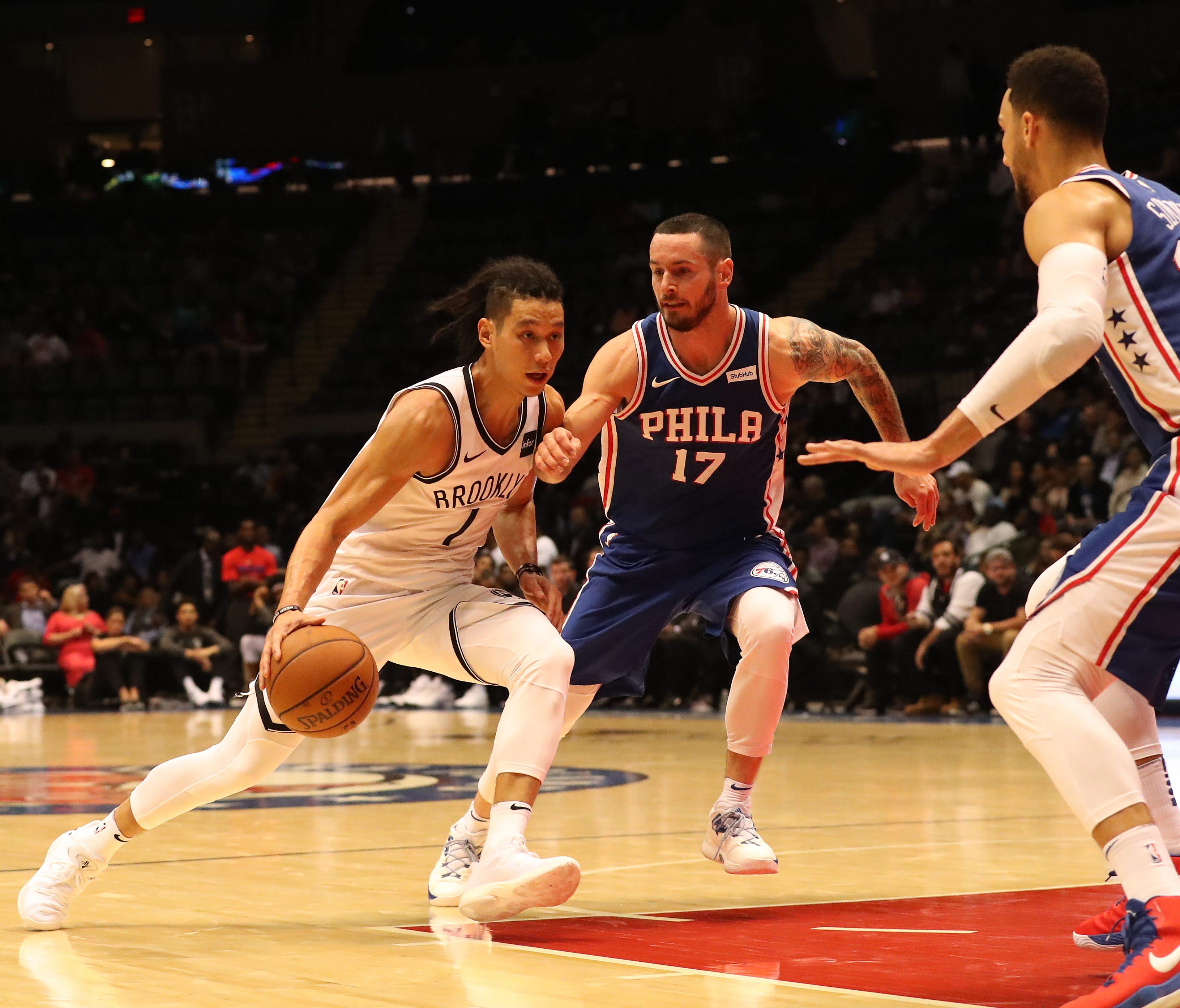 Brooklyn Nets guard Jeremy Lin (7) dribbles the ball as Philadelphia 76ers guard JJ Redick (17) defends during the third quarter at Nassau Veterans Memorial Coliseum.