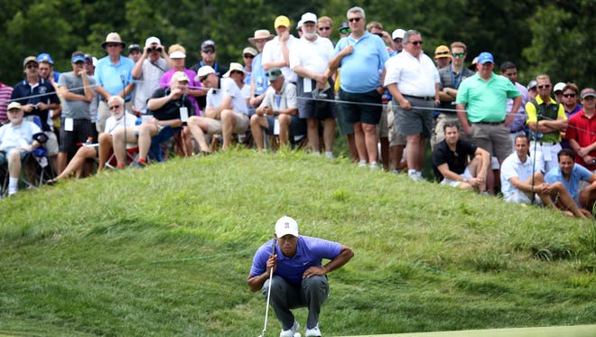 Tiger Woods looks over the green on the 5th hole during the first round of the 96th PGA Championship at Valhalla Golf Club in Louisville. Aug. 7, 2014.