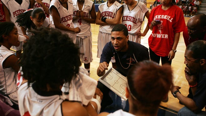 Rodney Headley, then the Peekskill basketball coach, talks to his players during a Class A regional final in 2011.