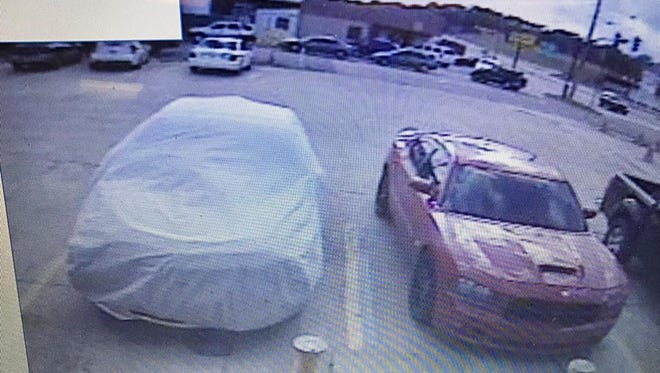 Police are seeking the owners or driver of this red Dodge Charger.