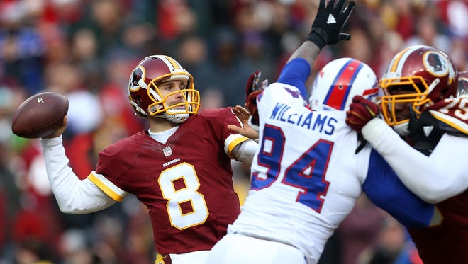 LANDOVER, MD - DECEMBER 20: Quarterback Kirk Cousins #8 of the Washington Redskins passes the ball while teammate tackle Ty Nsekhe #79 blocks against defensive end Mario Williams #94 of the Buffalo Bills in the third quarter at FedExField on December 20, 2015 in Landover, Maryland. (Photo by Matt Hazlett/Getty Images)
