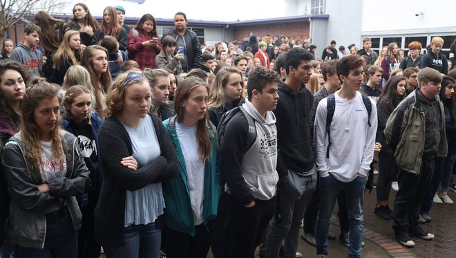 Students at Shasta High School listen as the names of victims from the Parkland, Florida, shooting are read aloud Wednesday at the school in Redding.