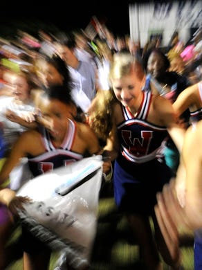 West fans rush the field following their team's 25-16 victory over Farragut in a high school football game at West High School in Knoxville on Friday, Sept. 20, 2013. 