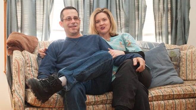 Tim and Angela Flick sit for a portrait in their home on Wednesday, Feb. 25, 2015. 