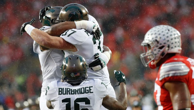 Michigan State Spartans fullback Trevon Pendleton (37) celebrates with Spartans quarterback Damion Terry (6) after scoring a touchdown against the Ohio State Buckeyes in the second quarter at Ohio Stadium.