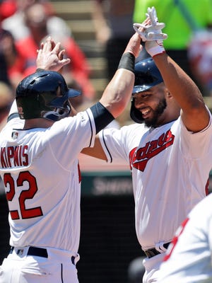 Cleveland Indians' Bobby Bradley, right, and Jason Kipnis celebrate after both score on a throwing error by Detroit Tigers' Niko Goodrum in the second inning in a baseball game, Sunday, June 23, 2019, in Cleveland. (AP Photo/Tony Dejak)