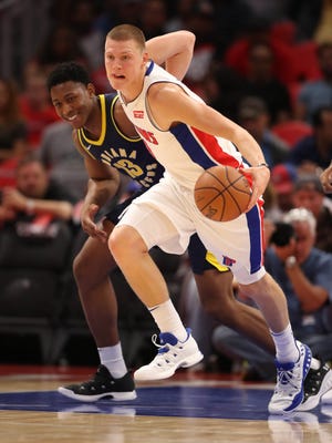Pistons forward Henry Ellenson rebounds against Pacers forward Ike Anigbogu during the first period of the 107-97 exhibition win over the Pacers on Monday, Oct. 9, 2017, at Little Caesars Arena.