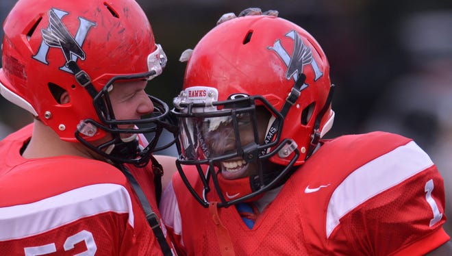 Huntingdon College's Austin Armstrong (52), left, congratulates Anthony White (1) after White intercepted a Averett University pass during their game at Huntingdon on Saturday, Nov. 8, 2014. 