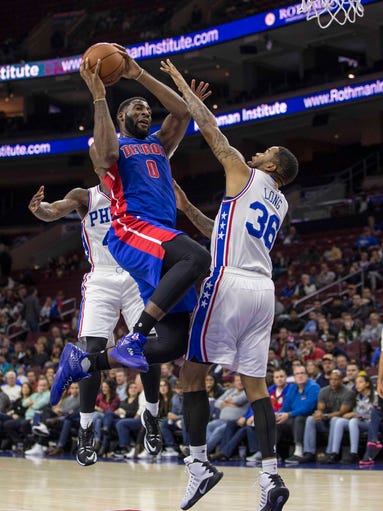 Detroit Pistons' Andre Drummond, center, goes up to