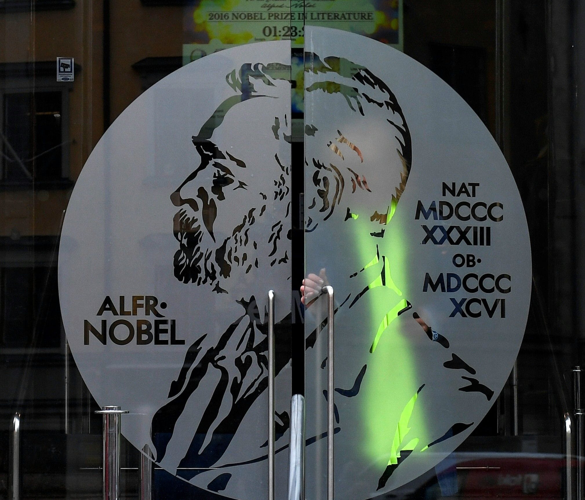 In this file photo taken on October 13, 2016, a visitor walks through the main entrance of the Nobel Museum at the Swedish Academy in Stockholm, Sweden, where the laureate of the 2016 Nobel Prize in Literature was announced.