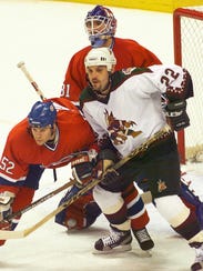 Coyotes right wing Rick Tocchet tries to hold his ground
