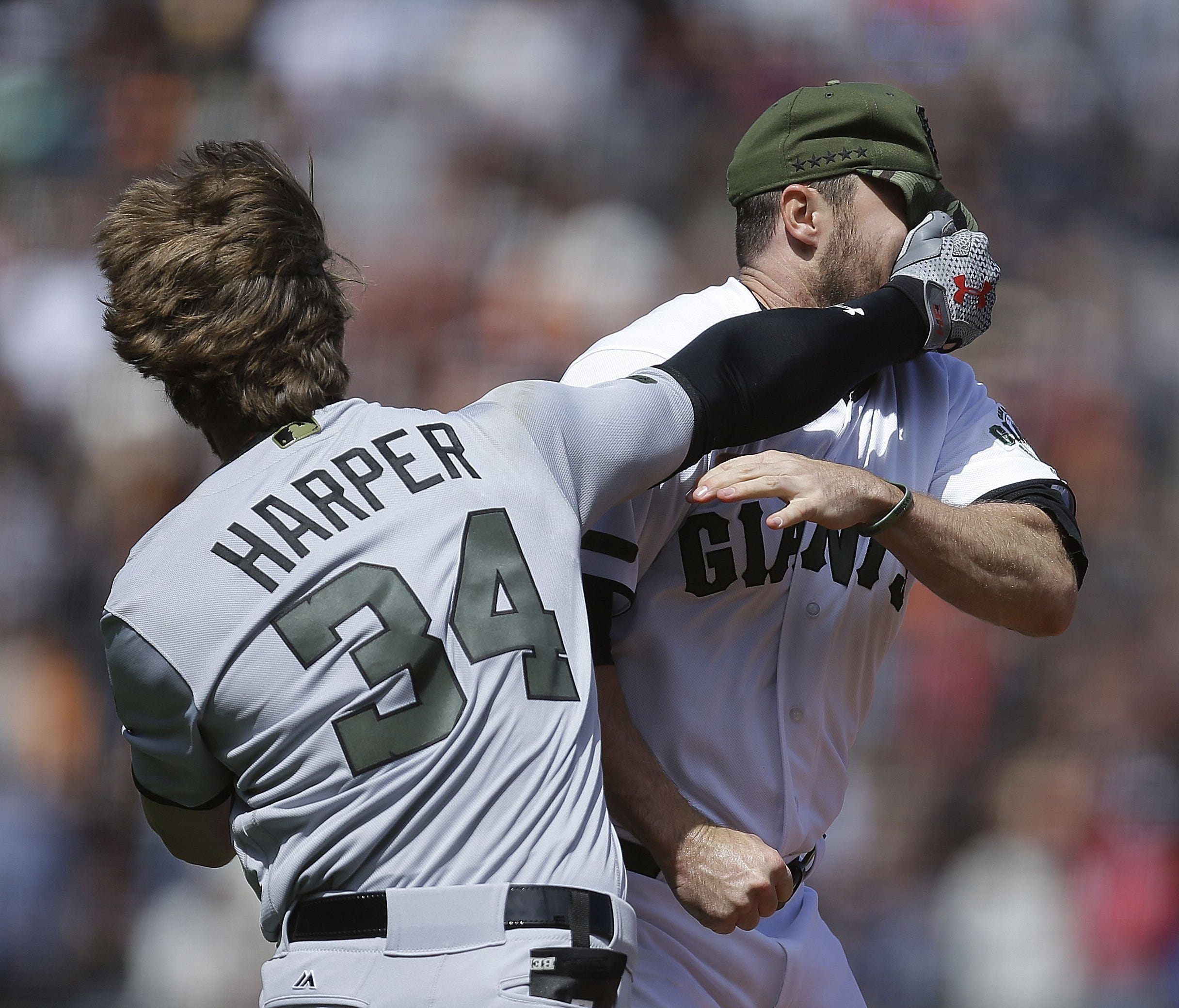 Bryce Harper exchanges blows with Giants reliever Hunter Strickland during an eighth-inning brawl Monday.