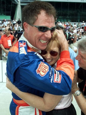 Race driver Darrell Waltrip hugs his wife, Stevie,