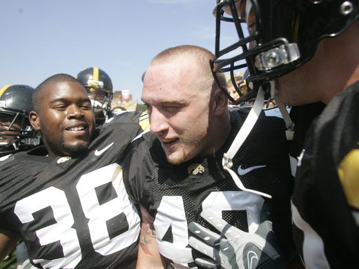 Iowa players mob around teammate Pat Angerer after