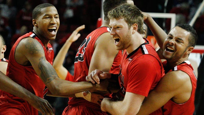 Incarnate Word guard Kyle Hittle (4) celebrates with teammates after hitting the game-winning shot against Nebraska The Cardinals play at Mackey Arena next season.