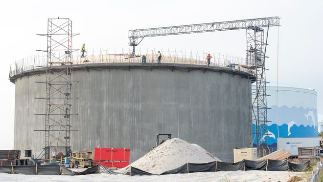 Workers construct a new water tank Monday, Dec. 4, 2017, along Pensacola Beach Boulevard in Pensacola Beach.