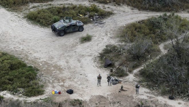 In this Feb. 24, 2015, file photo, members of the National Guard patrol along the Rio Grande at the Texas-Mexico border in Rio Grande City, Texas. The Trump administration is considering a proposal to mobilize as many as 100,000 National Guard troops to round up unauthorized immigrants, including millions living nowhere near the Mexico border, according to a draft memo obtained by The Associated Press.