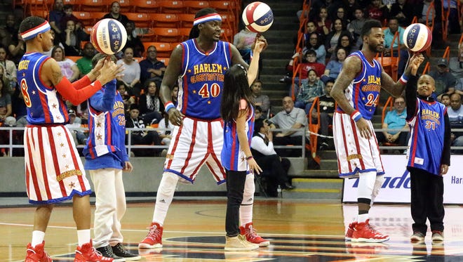Slick Willie Shaw, 40, and fellow Harlem Globetrotters Rocket Pennington, 8, and Dragon Taylor, 24, help three kids spin the ball on their finger in the middle of their game with the All Stars team in January 2017 in the Don Haskins Center. The famed wizards of basketball stopped by as part of their 2017 World Tour. The team, founded in 1926, has entertained more than 144 million fans in 122 countries and territories, their website states.