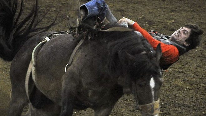 Josh Cragar, from Columbia, gets a little sideways as he holds on to "Shady Cat" at the 65th annual Franklin Rodeo.