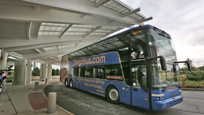 
A Megabus awaits patients leaving St. Francis Hospital on Oct. 14 in Greenwood. Patients were taken to area hospitals for treatment after a Megabus crashed earlier that day on I-65 near Greenwood.
