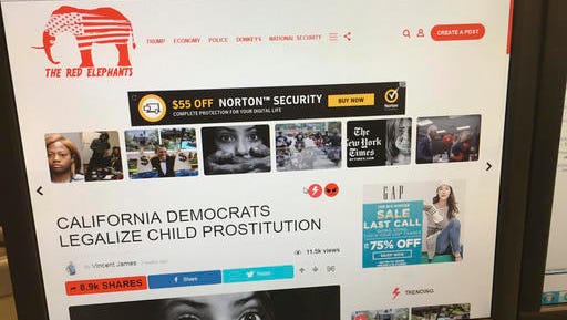 In this Thursday, Jan. 19, 2017, photo, a fake news story is positioned near ads from major global corporations on The Red Elephants website. It may not be intentional, but major corporations are helping prop up sites that publish false news stories. Experts say it’s not so easy for brands to make sure they don’t end up on websites that publish false stories.