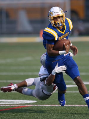 Irondequoit quarterback Freddy June Jr. is tackled from behind by Canandaigua's AJ Clifford as he scrambles downfield for yardage during their game Saturday, Sept. 16, 2017. 