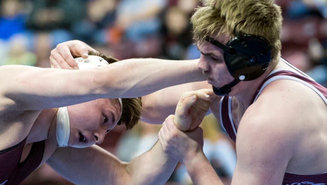 Shippensburg's Cole Forester, right, wrestles with Altoona's Parker McClellan during the 220-pound semifinals at Hershey's Giant Center for the PIAA 3A Championships, Saturday, March 10, 2018. McClellan won, 4-3. 