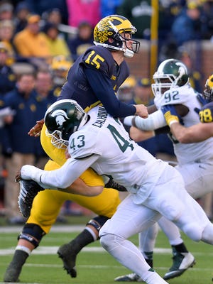 MSU's Shilique Calhoun smacks Michigan quarterback Jake Rudock in the second half in Ann Arbor Saturday 10/17/2015. 