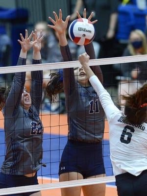 Greenwood's Anna Johnson, left, and Larkin Luke attempt to block the shot by Jonesboro's Rosalind Lutes in the first set of the 5A state championship match in the Hot Springs Convention Center on Saturday, Oct. 31. Greenwood defeated Jonesboro 3-0.