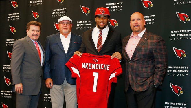 (From left) Arizona Cardinals President Michael Bidwill, head coach Bruce Arians and GM Steve Keim introduced their first-round draft pick, Robert Nkemdiche, a defensive tackle from Ole Miss at the Cardinals Training Facility in Tempe, Ariz., on Friday, April 29, 2016.