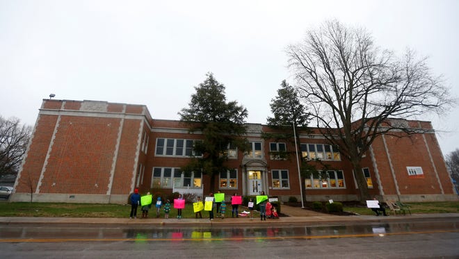 Parents and students protest outside of Campbell Elementary the proposal to turn the school into an early childhood education center on Monday, March 19, 2018.
