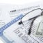 A Social Security card next to IRS form 1040, a pair of glasses, and a twenty-dollar bill.