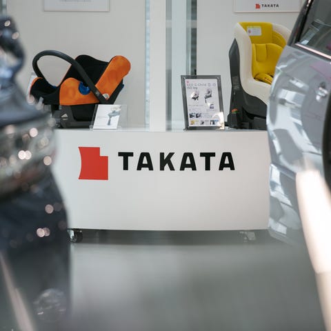 A Takata Corp. logo is seen on a display of child 