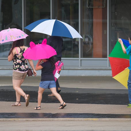 Light rain brought out the umbrellas for spectators in May 2018. The Oshkosh Memorial Day Procession made its way past hundreds of spectators along Algoma Boulevard before ending at Riverside Cemetery.