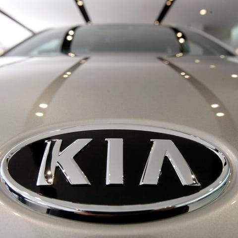 KIA Motors logo is seen on a K7 sedan at a showroo
