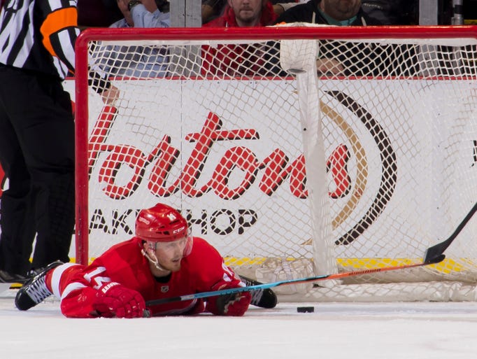 Red Wings center Gustav Nyquist lays on the ice after