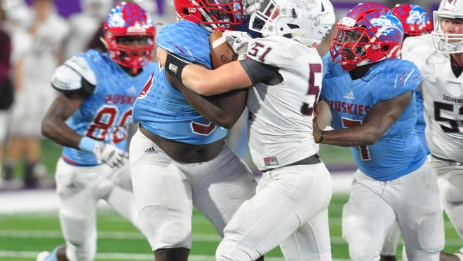 Brownwood offensive lineman Liam McGraw tackles Wichita Falls Hirschi defensive lineman Lloyd Murray after a fumble recovery during the Huskies' 44-34 win in a Region I-4A bi-district playoff Friday at Abilene Christian University's Wildcat Stadium.
