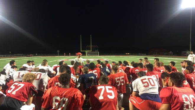 Dixie State head coach Shay McClure talks to his team after practice at Legend Solar Stadium. The Trailblazers look to improve on last year's 6-5 season.