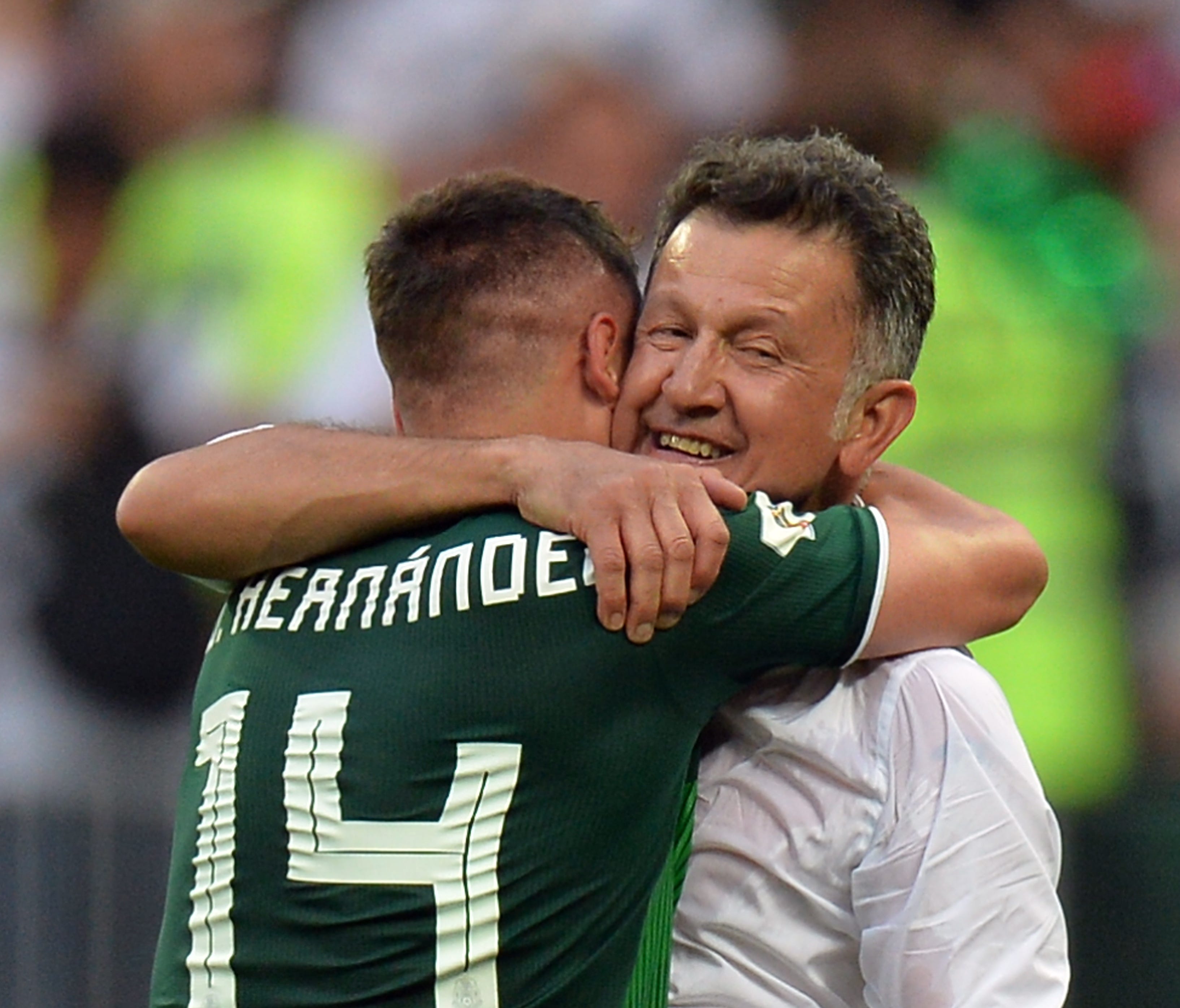 Mexico coach Juan Carlos Osorio and forward Javier Hernandez celebrate after beating Germany.