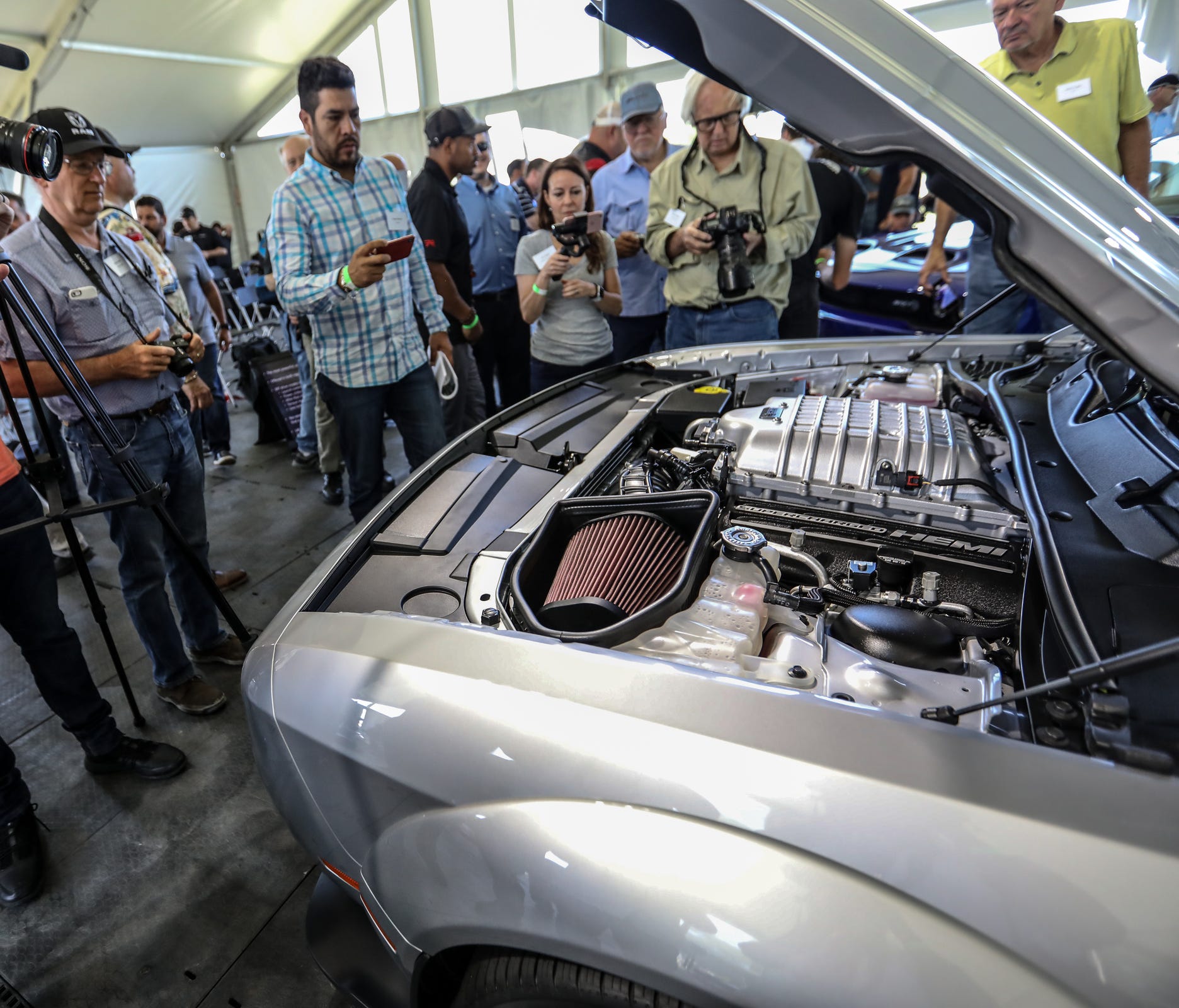 Journalists crowd around to get a look at the engine of the new 2019 Dodge Challenger SRT Hellcat Redeye during What's New event at Chrysler's Chelsea Proving Grounds in Chelsea, Mich. on Thursday, June 28, 2018.