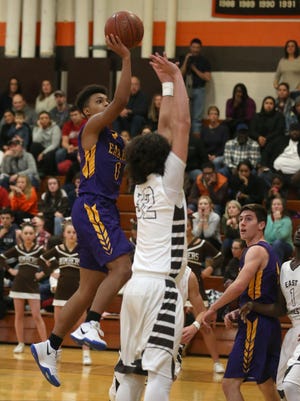 Clyde-Savanah's Marcus Chance Jr., left, drives into the lane for two past East Rochester's John Lexer.