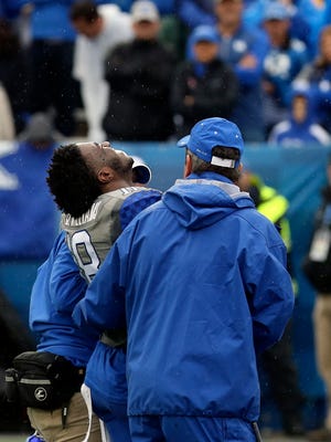 Kentucky's Stanley "Boom" Williams leaves the field in pain in the first half. Nov. 28, 2015