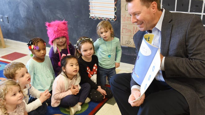 Milford Citizen of the Year Jack Shubitkowski reads a storybook to some pre-schoolers at the Carls Family YMCA on Nov. 11. Shubitkowski is the CEO of the Huron Valley State Bank and used to be the Y's President.
