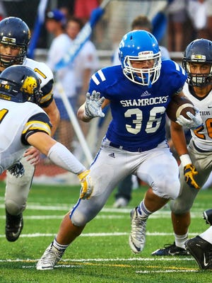 Catholic Central's Cameron Ryan (36) looks for daylight in Friday's game against Toledo Whitmer.
