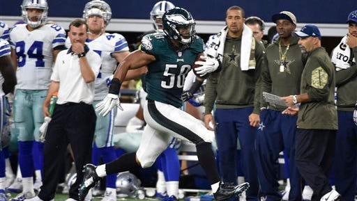 Eagles' linebacker Jordan Hicks (58) runs back an interception 67 yards for a touchdown in the against the Dallas Cowboys  on Sunday night.