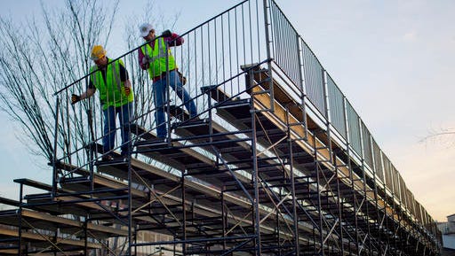 Workers install handrails for the bench seating along Pennsylvania Ave. in front of the White House in Washington, Friday, Jan. 13, 2017, as preparations continue for next week's Inauguration of President-elect Donald Trump.