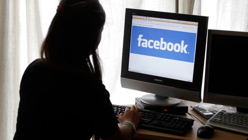 A girl looks at Facebook on her computer in Palo Alto, Calif. Most teenagers have taken a break from social media, according a new poll from The Associated Press-NORC Center for Public Affairs Research. The breaks are both voluntary and involuntary, such as when a parent takes their phone away as punishment.