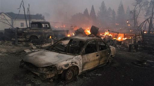 Vehicles and homes are destroyed in Weed, Calif. where a wind-driven wildfire raced through the hillside neighborhood and forced more than 1,000 people to flee the small town near the Oregon border. The fast-moving blaze, which began Monday, was among nearly a dozen wildfires burning in California that have been exacerbated by the state's third straight year of drought.
