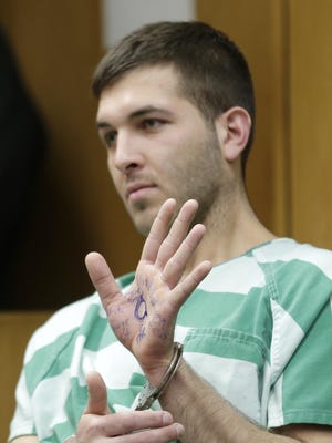 The man charged with killing the reputed boss of the Gambino crime family had a symbol on his hand that some say is associated with a conspiracy theory.